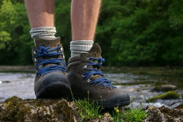 One men wear hiking boots stand on the rock