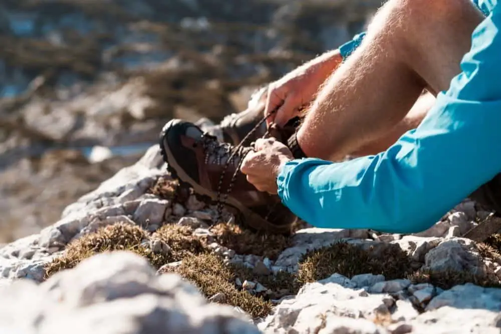 One men lacing his hiking boots