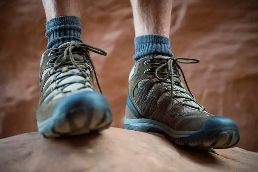 man wearing hiking boots and thick socks to prevent stones getting into