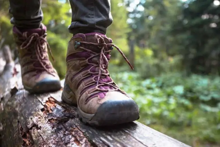 women wear hiking boots walk on the down tree