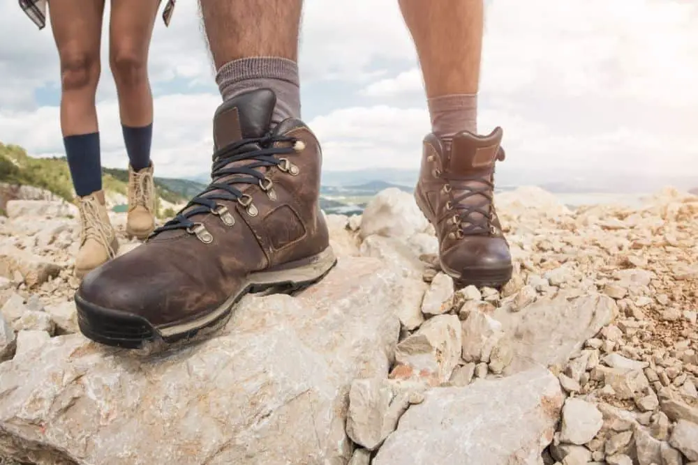 durable stiff hiking boots on rocky surface