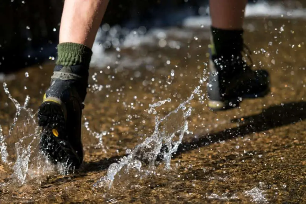 man wearing green socks with waterproof hiking boots