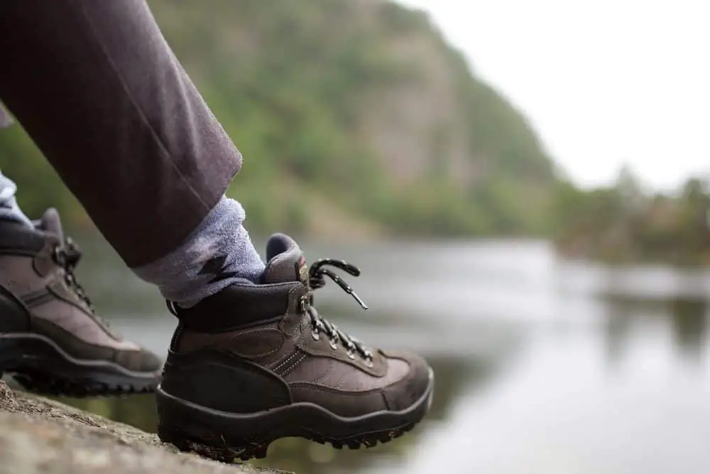 man wearing socks and hiking boots with right size