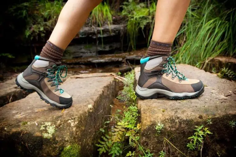 women wear hiking boots walk on the stone steps