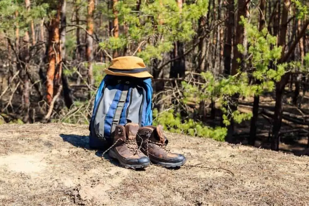 a light backpack with hat and hiking boots