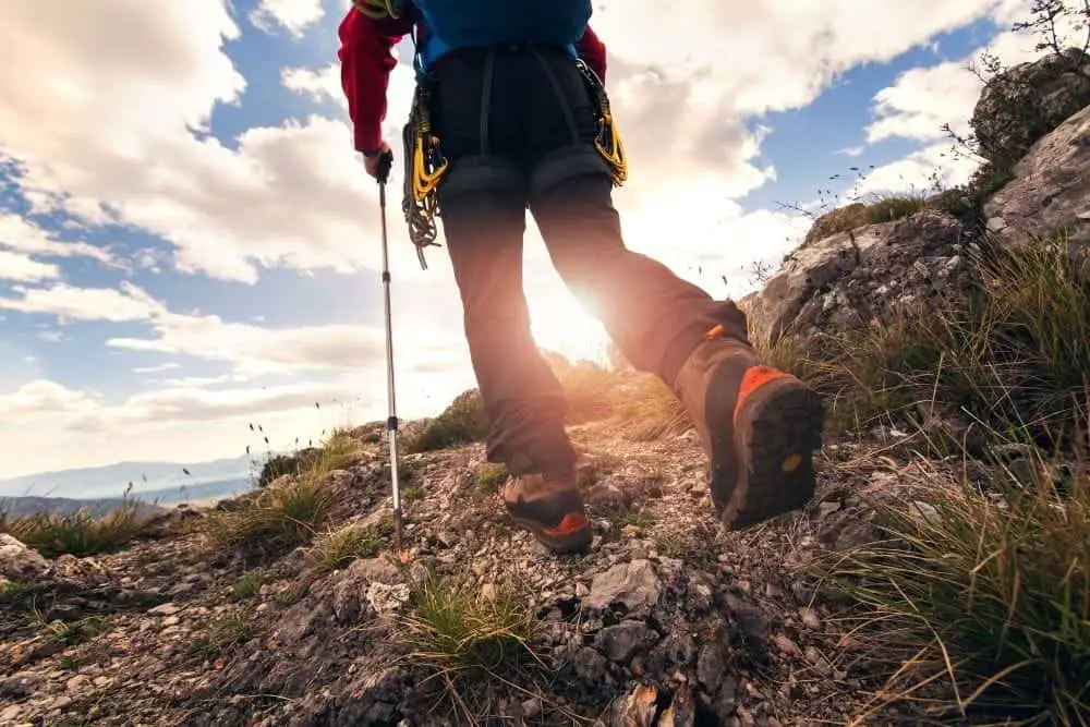 man wearing hiking boots on rugged outdoor terrain