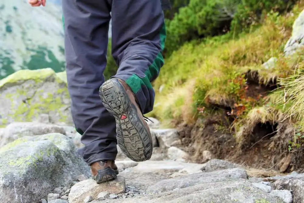 man wearing hiking boots with heel for shock absorption on rough terrain