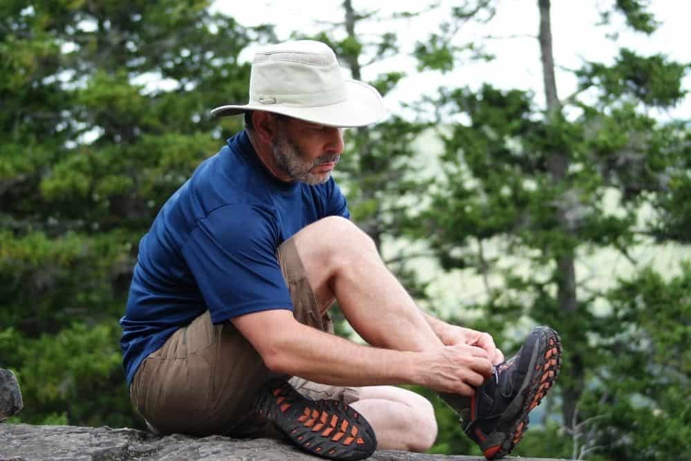 Wear hiking boots and shorts with a hat