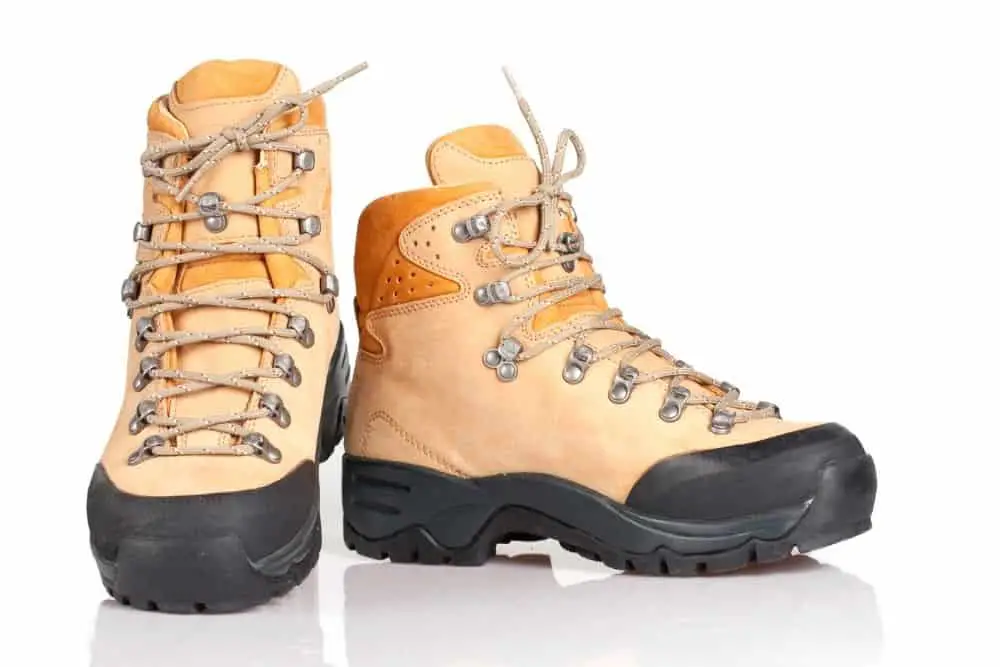 a pair of light colored hiking boots