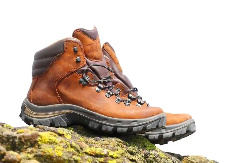 brown hiking boots made of thick leather on rock