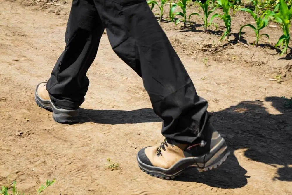 man wearing black pants with hiking boots