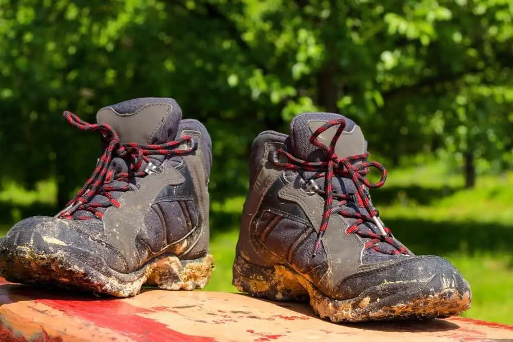 muddy hiking boots are dried in the sun
