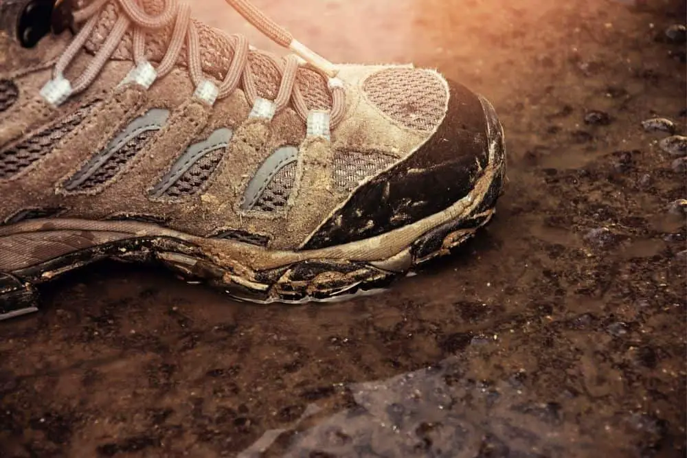 muddy hiking boots with vented holes