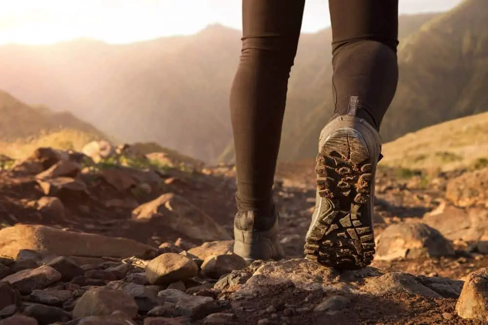 outsole of hiking boots on rugged terrain