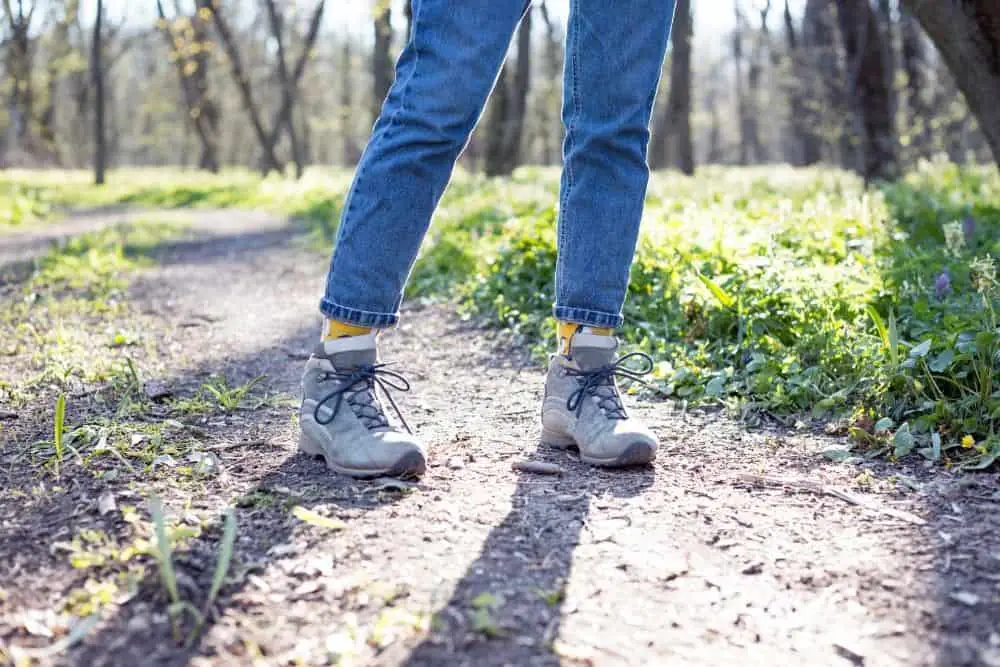 Girl wear jeans, hiking boots and colorful socks