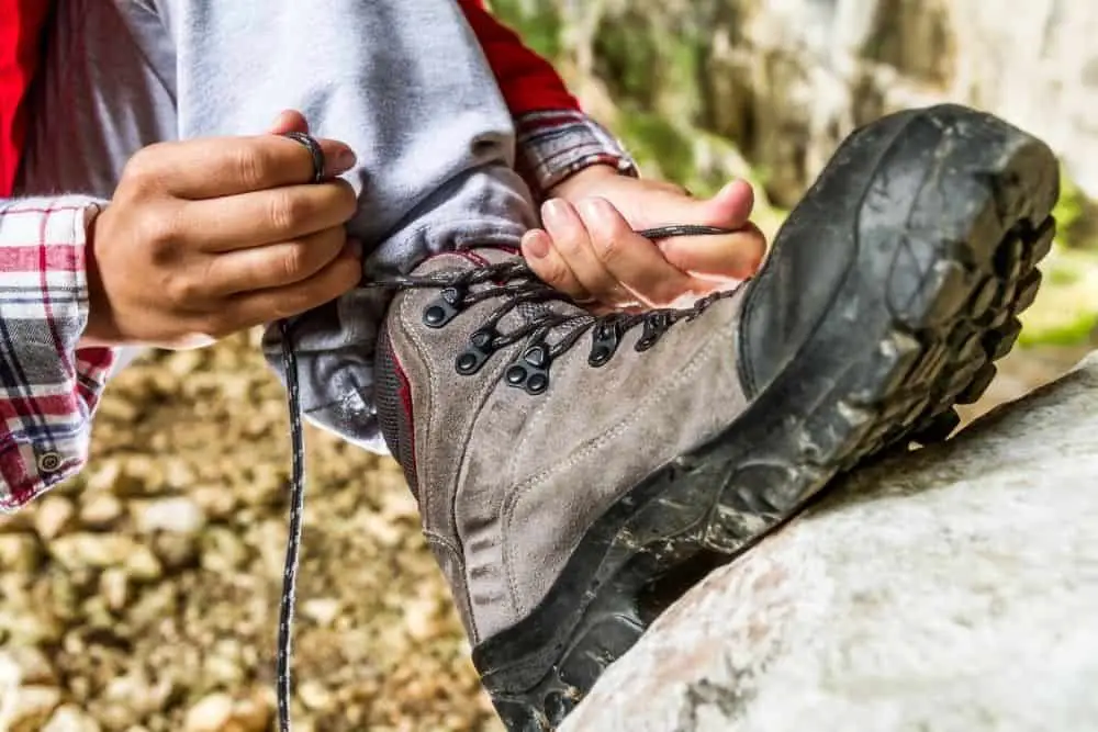 Men tightening his hiking boots