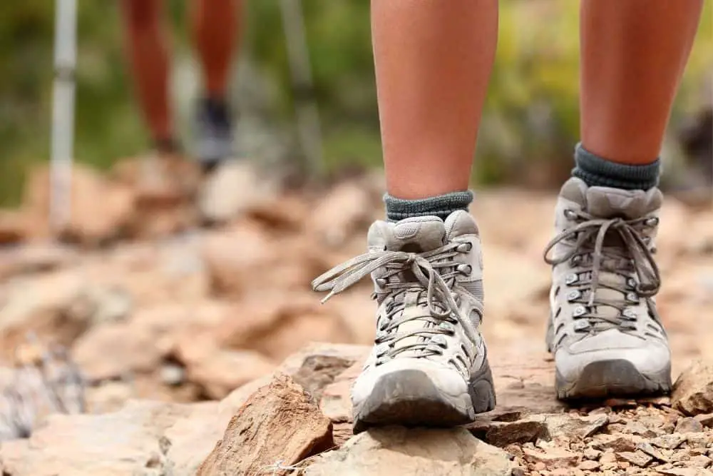 Women wear hiking boots in the dry, rocky terrain