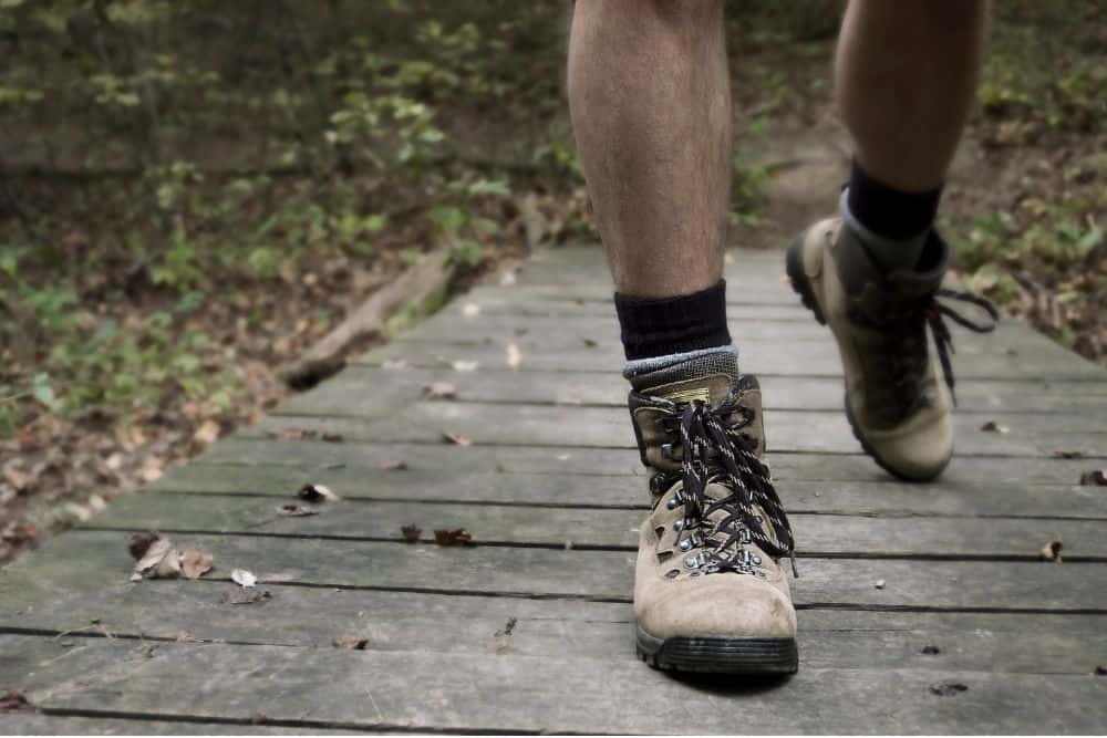 man walks in hiking boots to break in them