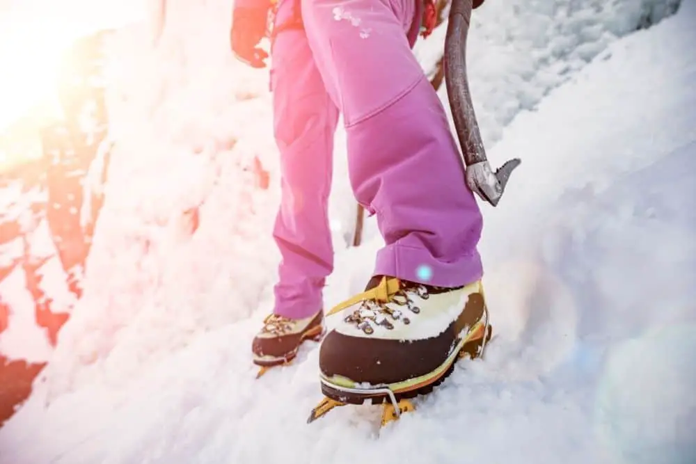 Yellow Crampons With Hiking Boots on snow