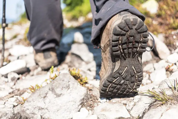 hiking boots with wide sole on rocks