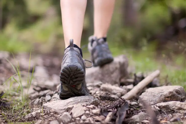 person trekking in hiking boots with flexible sole