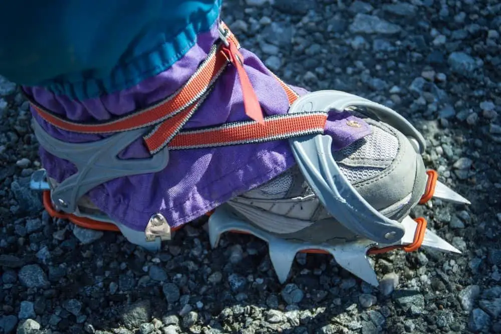 purple Crampons With red lace Hiking Boots on rock