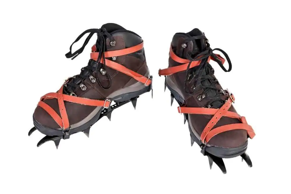 red Crampons With dark brown Hiking Boots