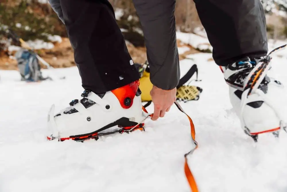 white Crampons With Hiking Boots in snow