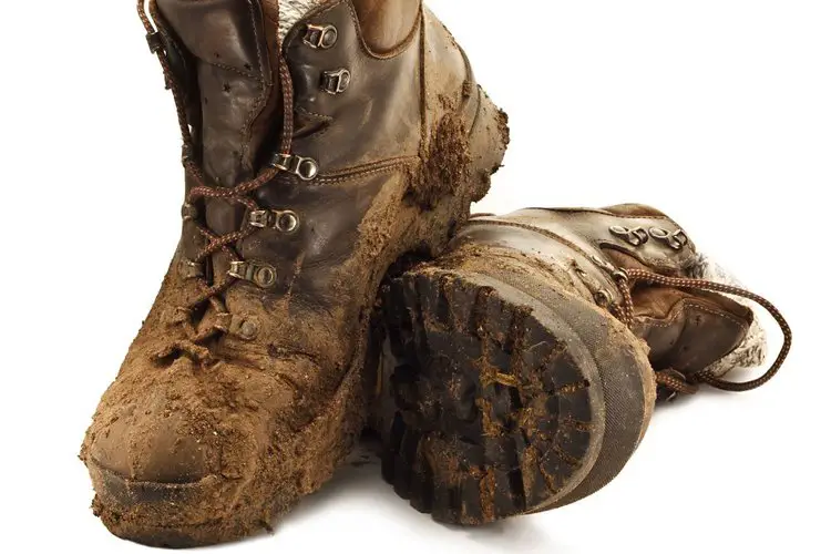 a pair of dirty and muddy hiking boots