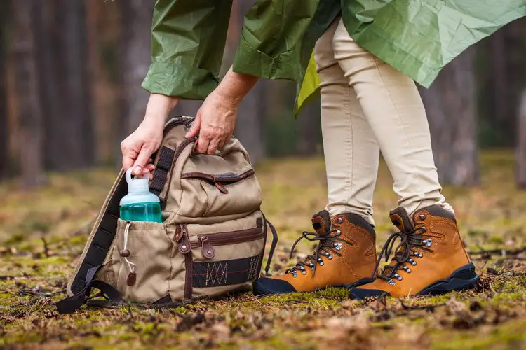 a woman wears leather hiking boots for hiking trip