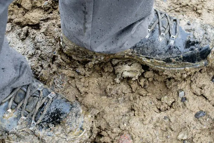 hiking boots with sticky wet clay mud