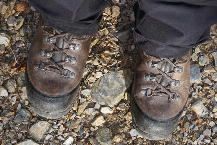 man wears durable leather hiking boots