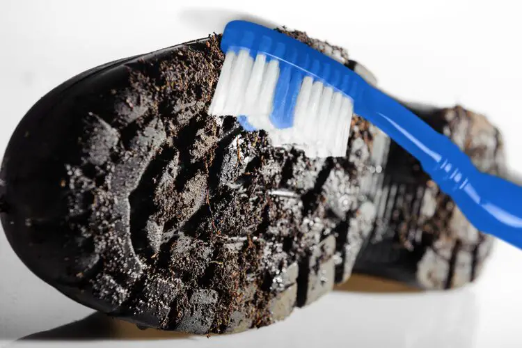 use a toothbrush to clean muddy hiking boot sole