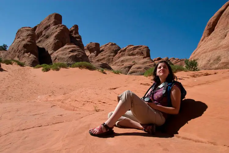 woman wears hiking sandals taking a rest
