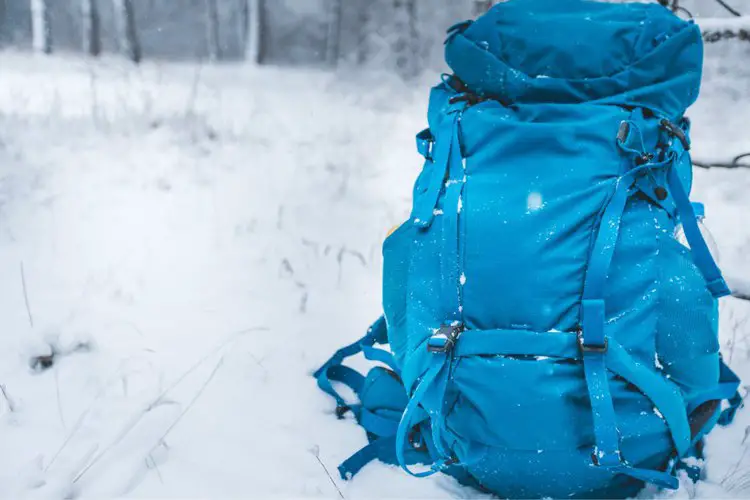 a blue big hiking backpack in the snow
