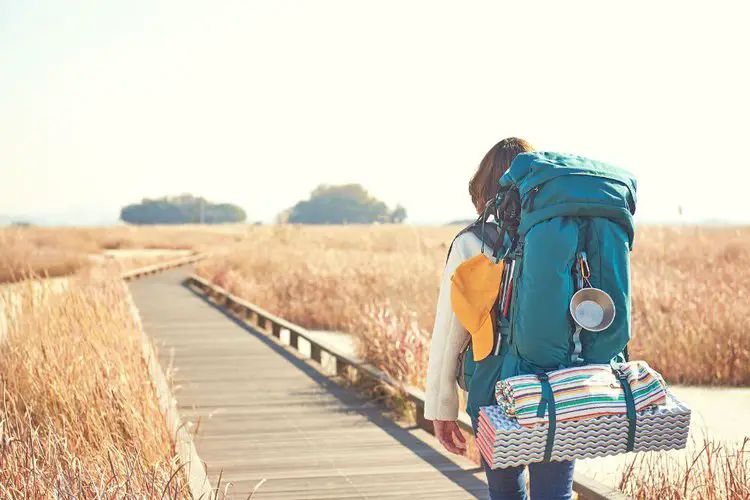 a girl wears expedition backpacks for long trip