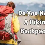 a girl with a red big hiking backpack