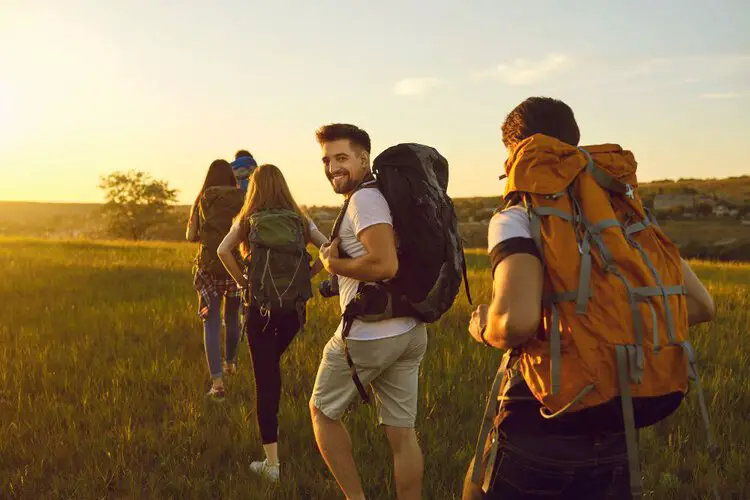 a group of friends join in a long trip with hiking backpacks