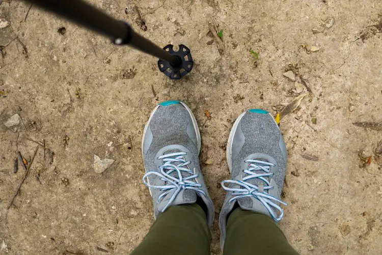 a hiking pole tip and pair of shoes