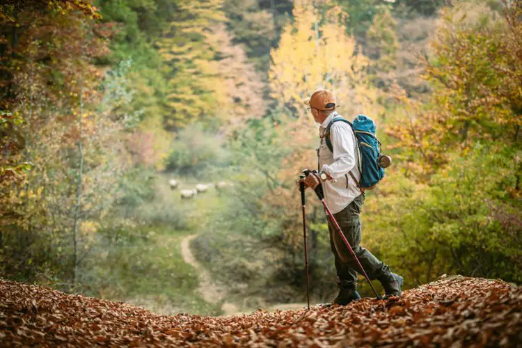 a man hiking with hiking poles for long distance