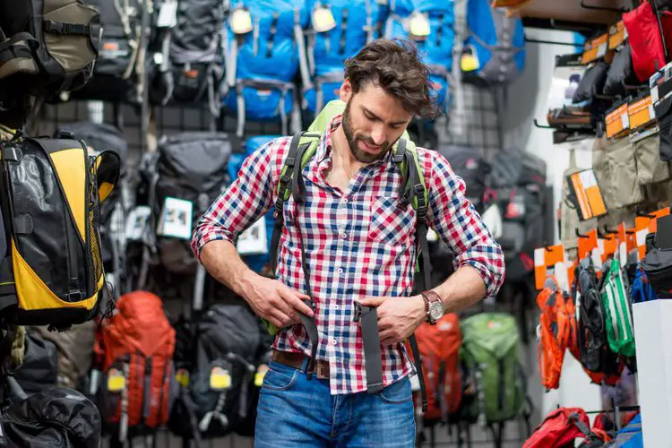 a man trying on new hiking backpack