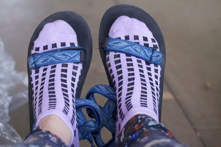 a person wears grip socks with hiking sandals