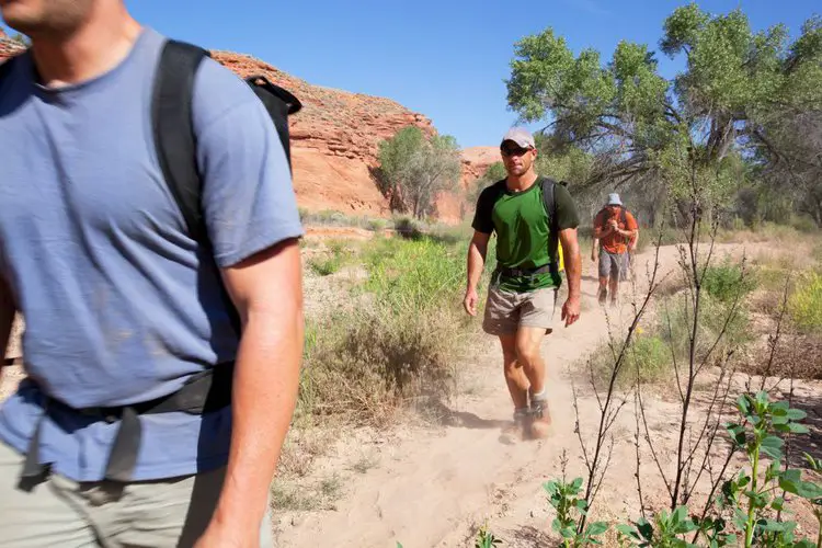 man goes hiking on a desert