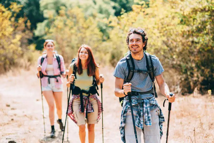 three friends hiking in hot weather