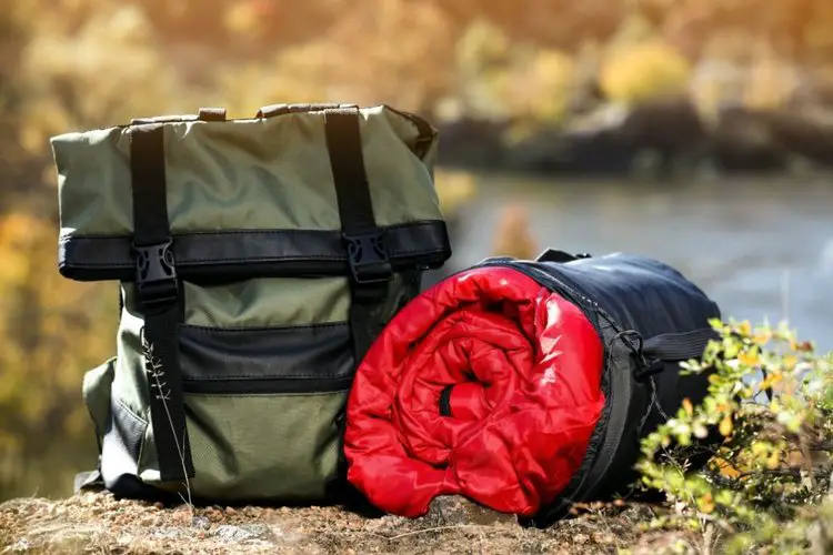 A hiking backpack and sleeping bag on the trail