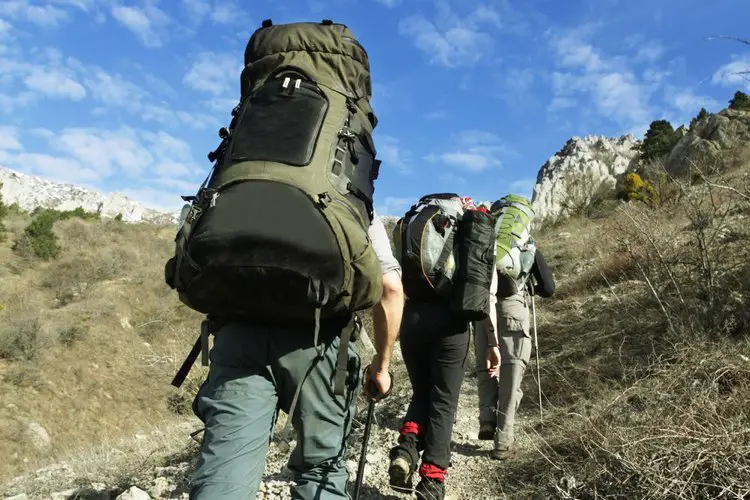 a man is walking on the mountain with Mountaineering hiking backpack