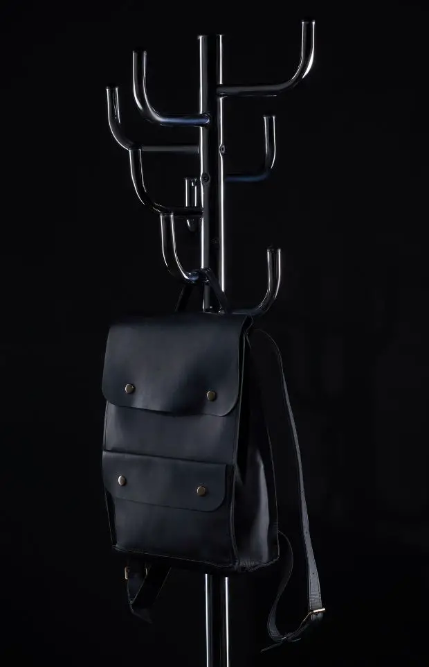 hang a black backpack on the coat rack