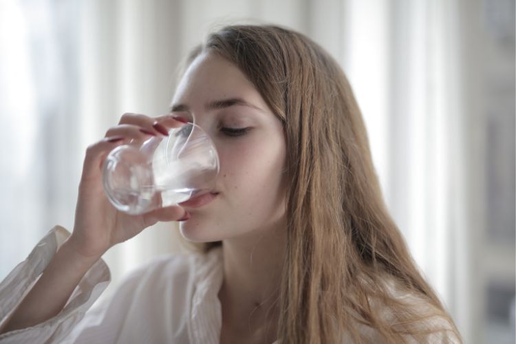 a girl is drinking water