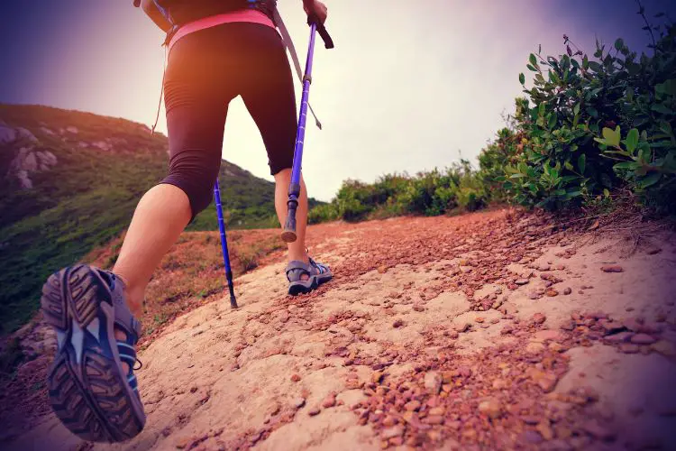 a girl is going uphill in leggings in her hiking trip