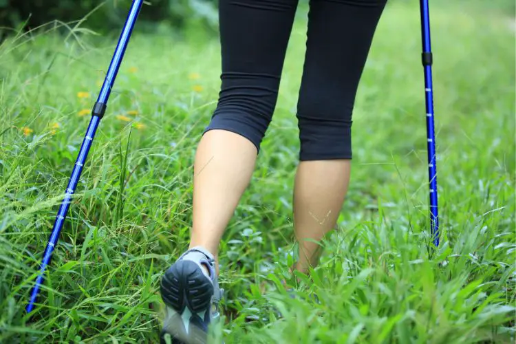 a girl wears leggings hiking through a grassy area